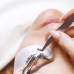 Eyelash Extension Procedure. Woman Eye with Long Eyelashes. Lashes. Close up, selected focus.