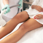 Close up of the medical worker conducting laser hair removal with a vacuum suction