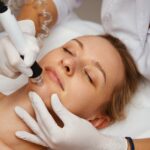 A cosmetologist performs hydropiling in a beauty salon. Skin care. High quality photo